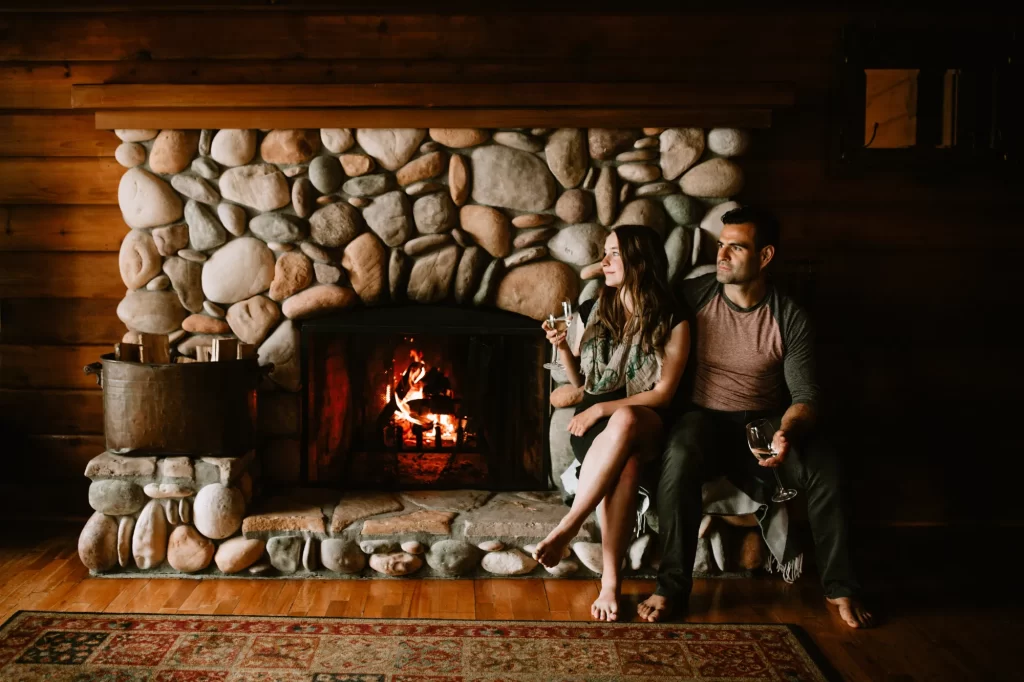 a couple with wine by the fire