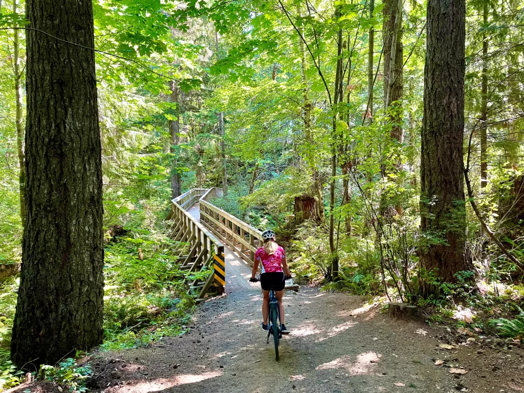a woman biking in the trees