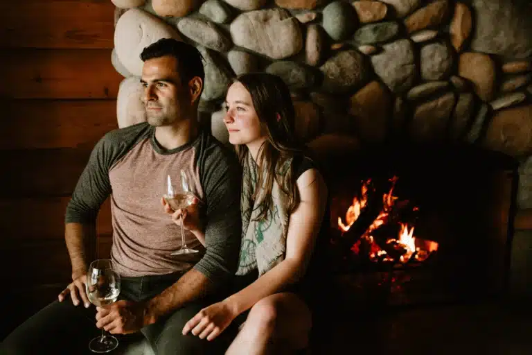 Guests by Fireplace Dolphins Resort | Bluetree Photography | Destination Campbell River